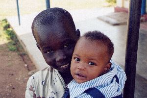 (Photograph of a small boy and a baby in Soroti)